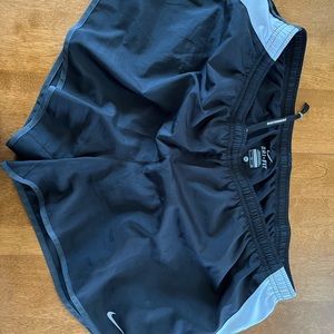 XL black with white side panels Nike Dri-Fit women’s running shorts.